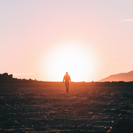 Silhouette of Hope: A Solitary Figure Walks Towards the Setting Sun