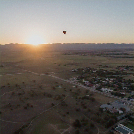 Serene Sunrise: Hot Air Balloon Soars Over Tranquil Town