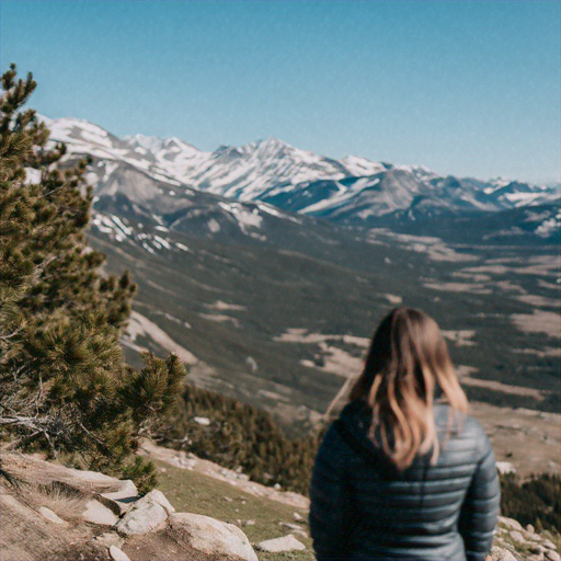 Contemplating the Vastness: A Woman Finds Serenity on a Mountainside