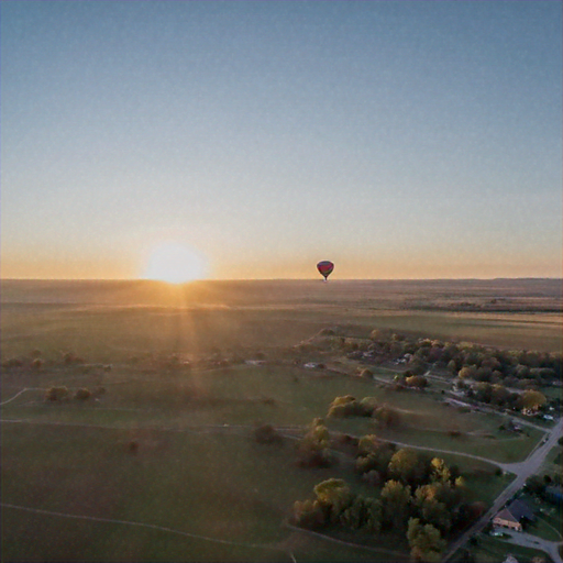 Sunrise Serenity: A Hot Air Balloon Soars Over Tranquil Landscapes