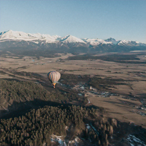 Soaring Serenity: A Hot Air Balloon Above a Snowy Mountain Range